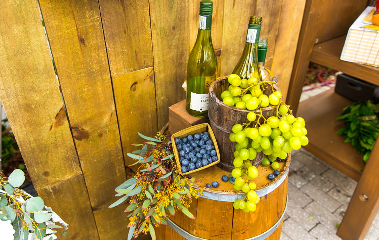 Wine barrel, wine bottle and grapes event decor